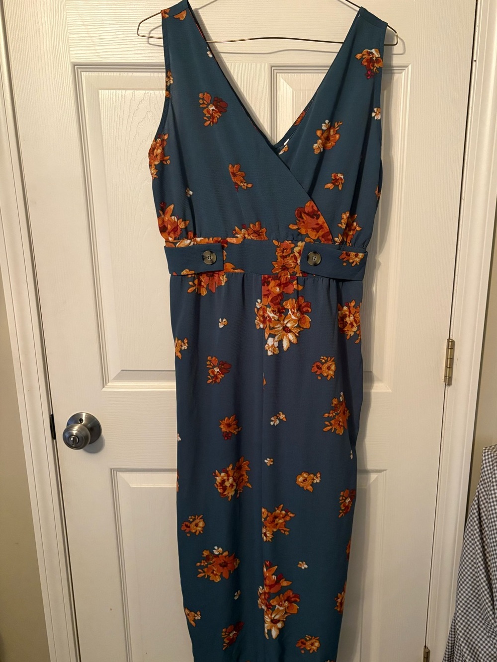 Sleeveless Teal Floral jumpsuit with button detail on waist. - Picture 1 of 1